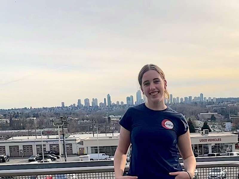 Isa in Canada Female teenager in front of city wearing blue t'shirt with Into logo